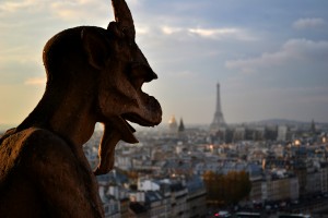 A Gargoyle on the towers of Notre Dame and the Eiffel Tower